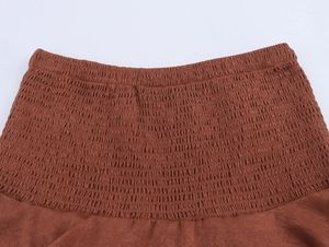 Macro view of brown smocked elastic waist detail with layered stitching for Y2K skirts