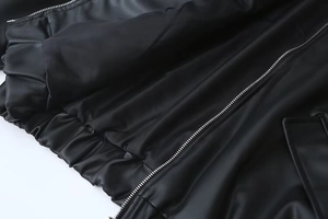 Detail of vintage PU leather jacket featuring silky lining, metal zipper and elastic hem