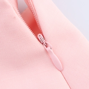 Macro detail of high-quality invisible zipper on pink woven fabric for women top