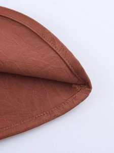 Chic backless tiered halter top in textured brown fabric with premium hem stitching details
