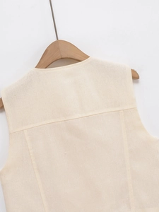 Detail of the oatmeal linen vest back stitching and natural woven fabric texture