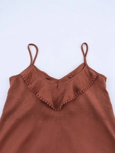 Women's backless camisole in rust brown with ruffled V-neck and pom-pom trim detail