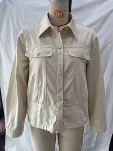 Detail of off-white retro work jacket with classic collar and chest flap pockets