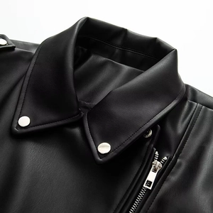 Close-up of black PU leather jacket lapel featuring silver metallic snaps and zippers