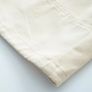 Close-up of beige twill cotton jacket cuff with durable double-needle stitching detail