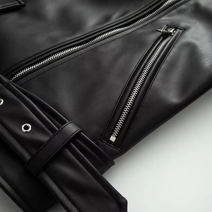 Detail of black faux leather biker jacket with silver zipper and metal eyelet belt