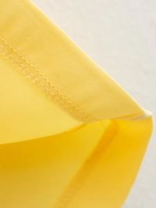 Close-up of bright yellow fabric showing neat stitching and twill texture detail