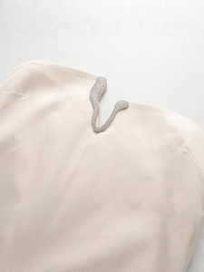Chic cream slim-fit dress featuring a V-shaped crystal embellished neckline detail