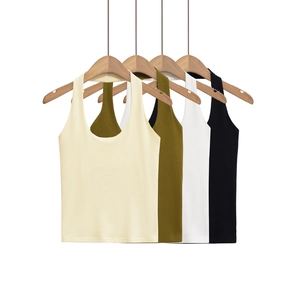 Row of ribbed knit halter tops in beige, green, white, and black on wooden hangers