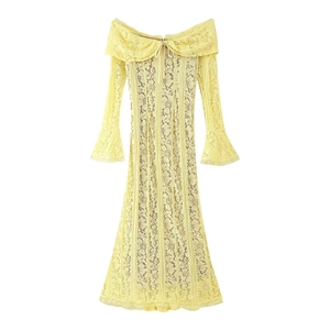 Flat lay of a light yellow lace dress with off-the-shoulder neckline and bow detail