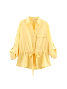 Women's pale yellow long sleeve waist-tie shirt with cargo pocket and lapel collar