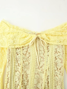 Pale yellow off-shoulder lace dress featuring ruffled neckline and delicate front bow detail