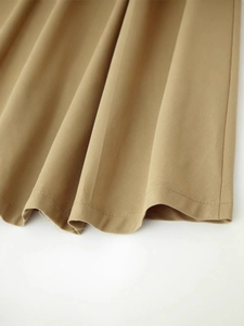 Summer khaki minimalist sleeveless dress with belt showing textured twill fabric hem