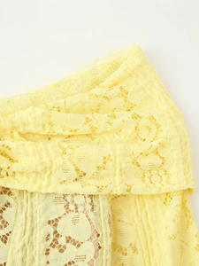 Detail view of floral eyelash lace fabric on an off-shoulder yellow dress with inner lining