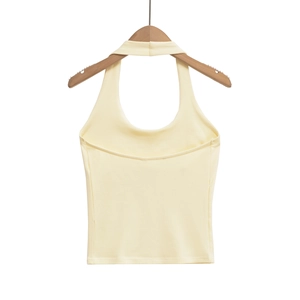Detailed view of cream yellow halter neck crop top with ribbed knit texture