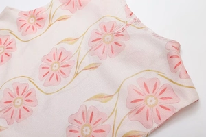 Detail von Leinenstoff mit Blumendruck und hochwertigen Nähten an einem Sommerkleid