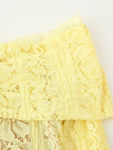 Detail of yellow floral lace hem with delicate eyelash lace trim and hollow embroidery