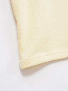 Close-up of light yellow ribbed knit fabric texture and durable double-needle stitching