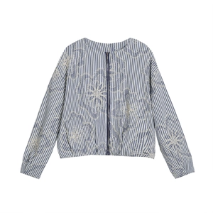 Detail of blue striped bomber jacket featuring delicate floral embroidery and zipper
