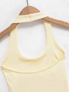 Close-up of light yellow halter neck top showing fine ribbed knit fabric texture on hanger