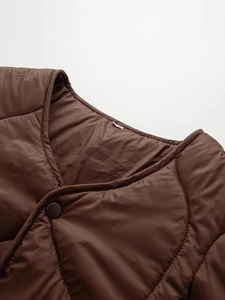 Deep brown quilted vest with wave patterns and V-neckline featuring a single snap button