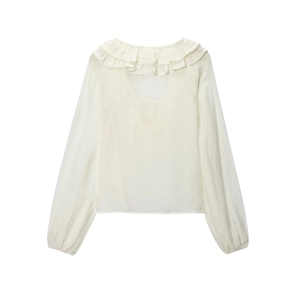 Detailed macro view of French vintage ruffled collar and textured chiffon fabric in cream