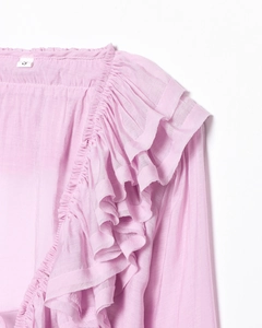 Detail view of pink layered ruffle sleeves and pleated neckline on a chiffon blouse
