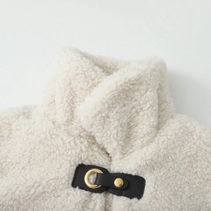 Detail of high-quality faux shearling coat collar with black leather buckle and gold ring