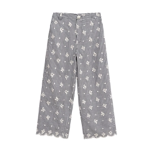 Pantalon large à carreaux noir et blanc avec broderie florale blanche pour l'été chic