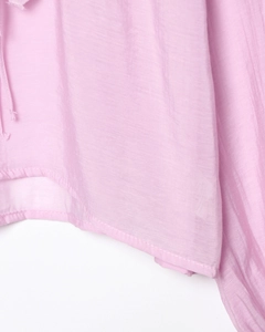 Detailed macro view of the light pink chiffon fabric texture and high-quality hem stitching