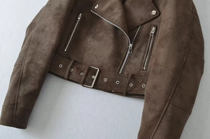 Detail of dark brown faux suede biker jacket with silver zippers and waist belt