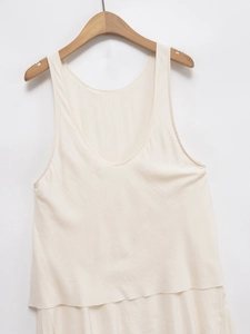 Minimalist beige layered sleeveless summer dress featuring a deep round neck and flowy hem