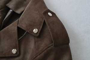 Close-up of brown suede biker jacket showing collar, epaulets and metallic silver snap buttons