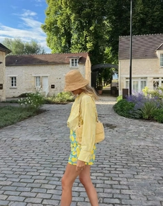 Street style view of striped long sleeve shirt with vibrant lemon print mini skirt