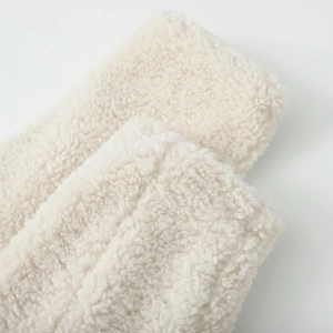 Close-up of soft white sherpa faux fur texture on the collar of a winter coat