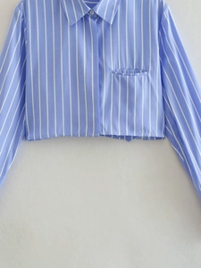 Close-up of classic lapel collar and single chest pocket on blue striped short shirt