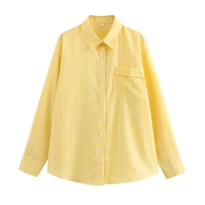 Detail of yellow striped long sleeve shirt showing collar button and front chest pocket
