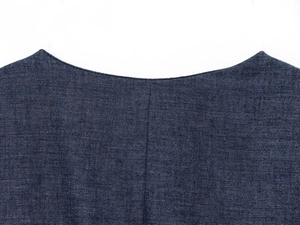 Detail of dark blue crew neck top showing high-quality linen texture and double stitching