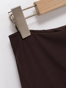 Detailed macro view of the dark brown midi skirt waist with clean stitching craftsmanship