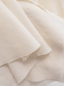 Detailed macro view of ivory white twill fabric texture for summer backless layered dress