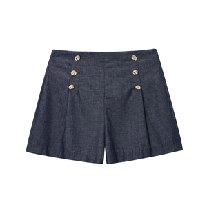 Detailed macro view of navy blue high-waist shorts featuring golden double-breasted buttons