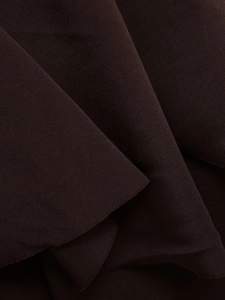 Macro texture view of dark brown high-density midi skirt fabric showing soft folds