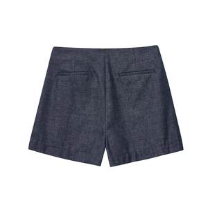 Detailed view of high-waist dark blue linen shorts with back welt pockets and textured fabric