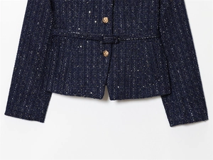 Close-up of navy tweed jacket with sparkling gold sequins and vintage metal buttons