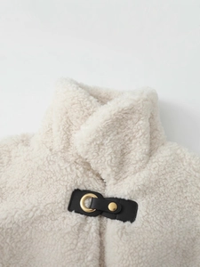 Women's faux shearling coat with stand collar and decorative leather buckle straps