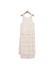 Sleeveless tiered layered summer dress in beige hanging on a wooden hanger
