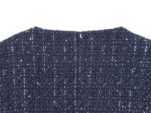 Detail shot of navy blue tweed fabric with woven golden sequins and textured fibers