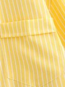 Detail of yellow and white vertical stripe fabric and chest pocket stitching