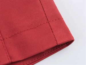 Detail der roten Frühlingsjacke mit feiner Köperstruktur und präzisen Steppnähten