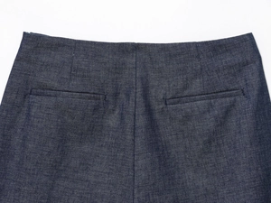 Detail view of deep blue linen-blend shorts featuring back welt pockets and neat stitching